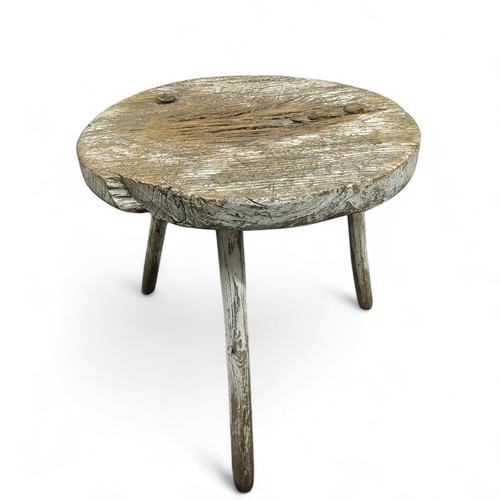 426 - An 18th century rustic cricket table, circular top, white painted, 59cm high, 52cm diam