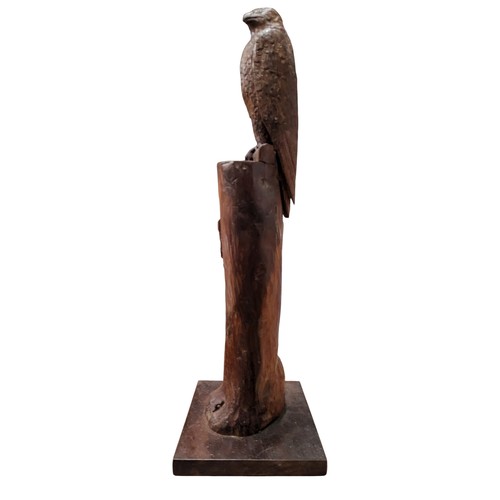 330 - A 20th century carved wood sculpture, of a hawk, perched on a tree bough, a dead bird to the base, 5... 