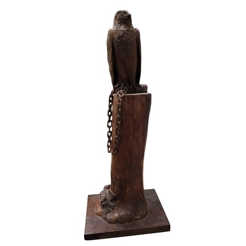 330 - A 20th century carved wood sculpture, of a hawk, perched on a tree bough, a dead bird to the base, 5... 