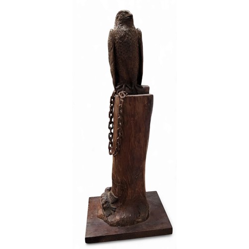 330 - A 20th century carved wood sculpture, of a hawk, perched on a tree bough, a dead bird to the base, 5... 