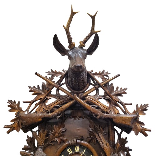 655 - A fine 19th century Black Forest carved limewood spring driven cuckoo clock, Jagdstück/hunt piece, t... 