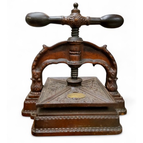 295 - A 19th century French cast iron book press, moulded with scrolls, brass label Papeterie Giles Rouen,... 