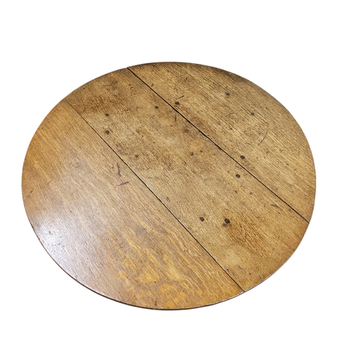 689 - A late 18th century English oak joined folding cricket table,  circular top, block stretchers, 71cm ... 