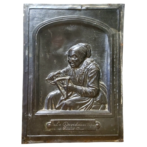 299 - A 19th century French repousse plaque, in the manner of Gerrit Dou, depicting a 17th century lace ma... 