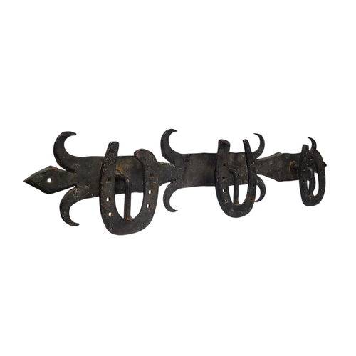 499 - Equestrian interest - a 19th century wrought iron tap room coat rack, applied horse shoe hooks, 15cm... 