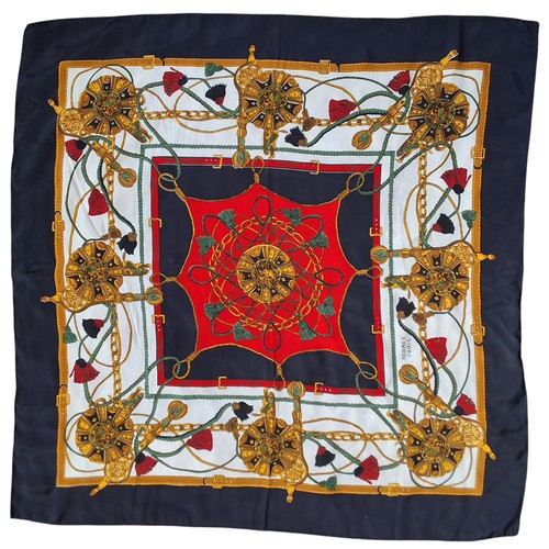 603 - A vintage classic Hermes silk scarves,  in tones of black, gold, green and red, black border, signed... 