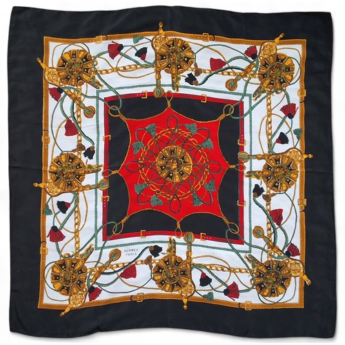 603 - A vintage classic Hermes silk scarves,  in tones of black, gold, green and red, black border, signed... 