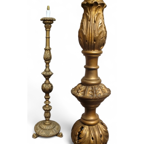 349 - A Louis XVI style giltwood standard lamp, profusely carved throughout raised on paw feet, 170cm high