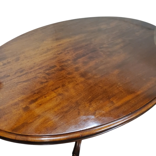 459 - An early Victorian mahogany oval breakfast table, tilt top, boldly carved pedestal, castors, 73cm x ... 