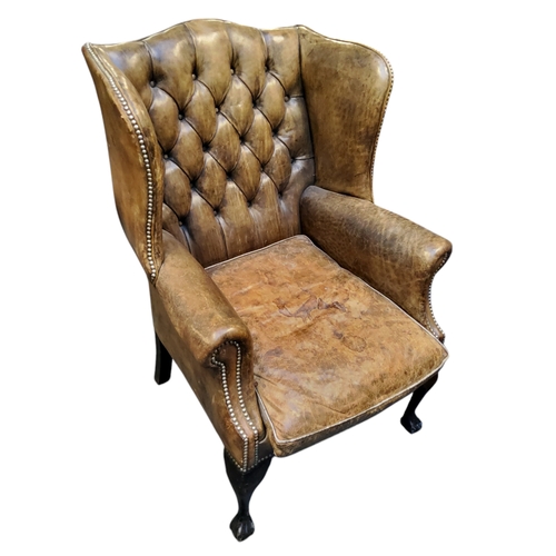 672 - A George III Revival wingback armchair, in olive green leather, cabriole forelegs terminating with b... 