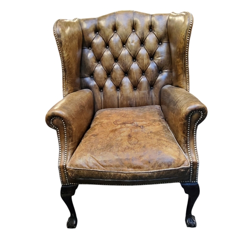 672 - A George III Revival wingback armchair, in olive green leather, cabriole forelegs terminating with b... 