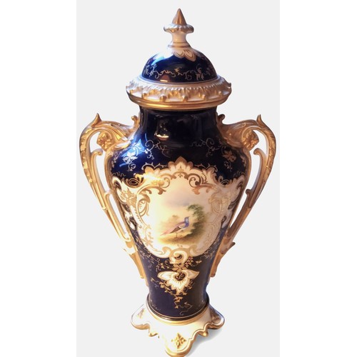 86 - A Coalport two handled ovoid vase and cover,  painted with a fanciful bird within a gilt scroll cart... 