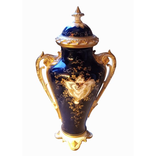 86 - A Coalport two handled ovoid vase and cover,  painted with a fanciful bird within a gilt scroll cart... 