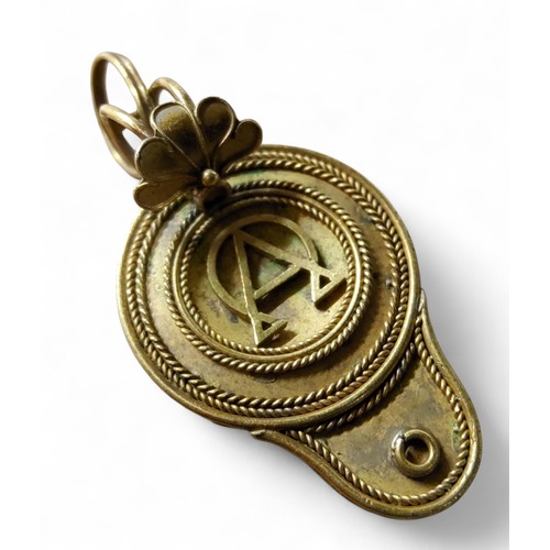 30 - An Antonio Carli gold coloured metal mourning pendant,  in the form of a Roman lamp, the back set ha... 