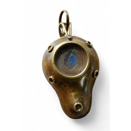 30 - An Antonio Carli gold coloured metal mourning pendant,  in the form of a Roman lamp, the back set ha... 