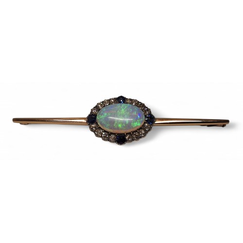 29 - A rose gold coloured metal bar brooch, the central setting set with a oval black opal 12 x 19mm, bor... 