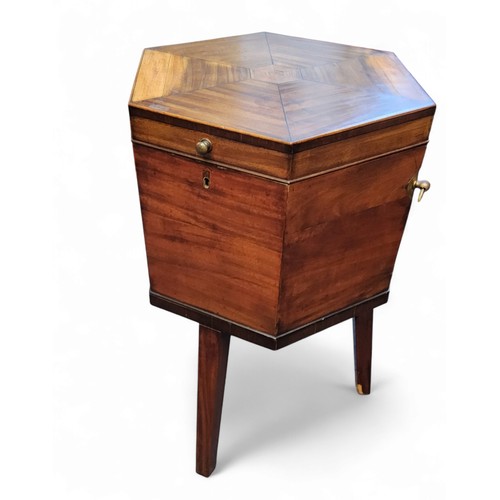 634 - A George III mahogany octagonal cellaret, hinged cover, the stand with tapered square legs, lead lin... 