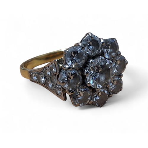 37 - AMENDED DESCRIPTION - An 18ct gold diamond floral cluster ring, the platinum setting set with a cent... 