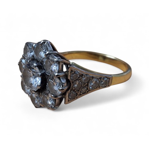 37 - AMENDED DESCRIPTION - An 18ct gold diamond floral cluster ring, the platinum setting set with a cent... 