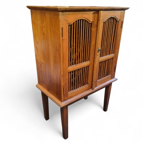 262 - A French chestnut wine cabinet, thirty bottle compartments, spindle fronted doors, tapering legs, 12... 