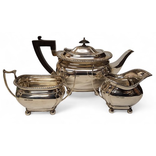 1 - A George VI silver three piece boat shaped tea service, comprising teapot, milk jug and sugar bowl, ... 