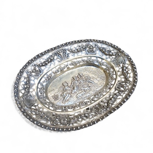 7 - A 19th century German silver oval bonbon dish, the rim decorated in relief with roses, pierced borde... 