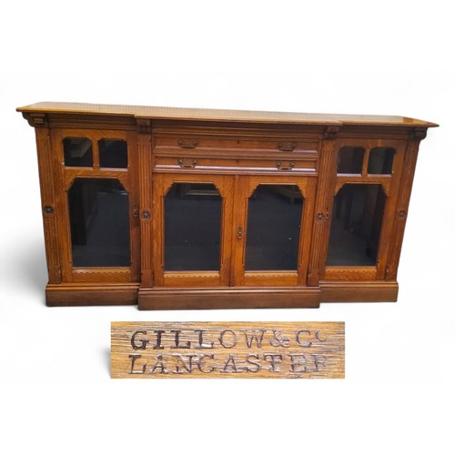 646 - Gillows of Lancaster - a substantial Victorian oak break-centre  library cabinet, with two central d... 