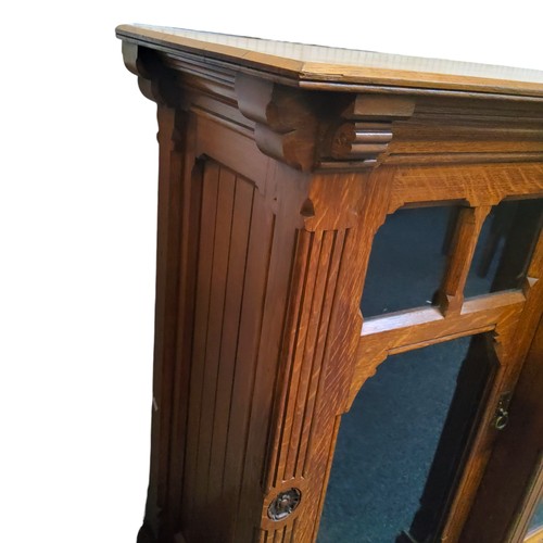 646 - Gillows of Lancaster - a substantial Victorian oak break-centre  library cabinet, with two central d... 