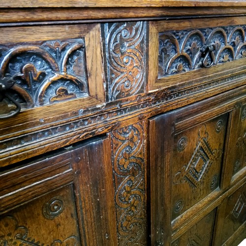 622 - An English oak court cupboard, the upper section with a dental frieze above two block fronted cupboa... 