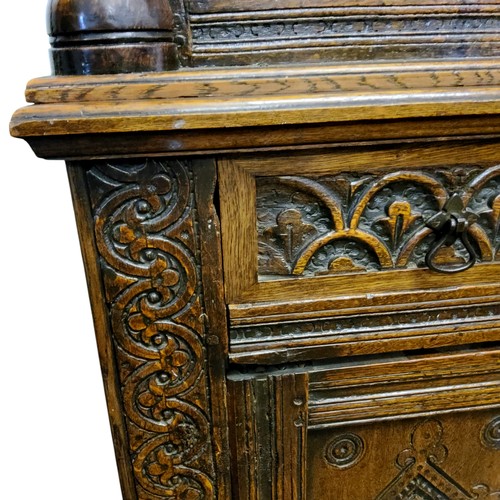 622 - An English oak court cupboard, the upper section with a dental frieze above two block fronted cupboa... 