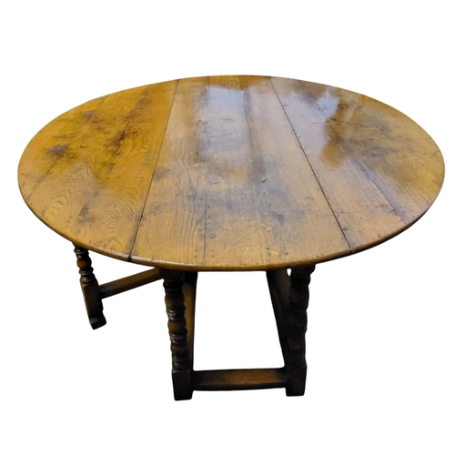 694 - Attributed to Titchmarsh and Goodwin, an 18th century style golden oak dropleaf gateleg oval dining ... 