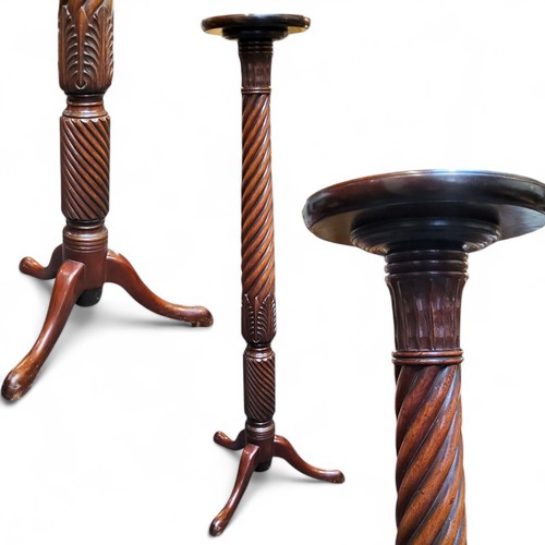 649 - A 19th century mahogany torchere, circular top, stiff acanthus and spirally turned columns, tripod l... 