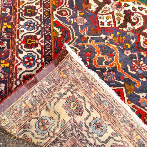 375 - An Oriental Keshan carpet, vivid colours of red, ivory and green, 300cm x 215cm