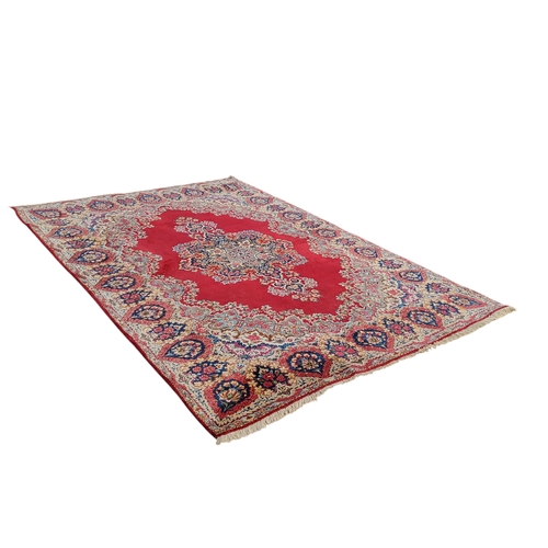 708 - An Oriental Kerman carpet, vivid tones of red and blue, 353cm x 245cm