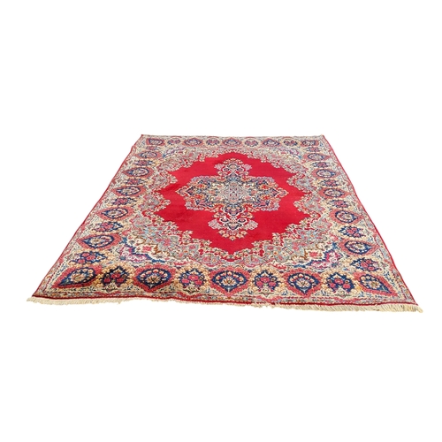 708 - An Oriental Kerman carpet, vivid tones of red and blue, 353cm x 245cm