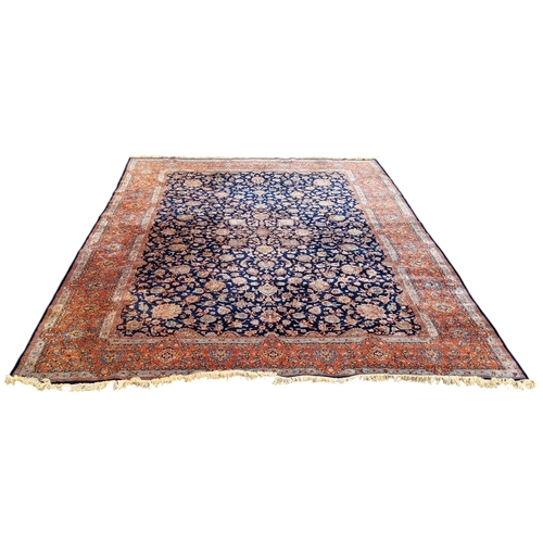 709 - A 19th century hand knotted Persian carpet, signed, in vivid tones of blue, terracotta and ivory, co... 