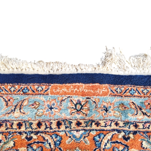 709 - A 19th century hand knotted Persian carpet, signed, in vivid tones of blue, terracotta and ivory, co... 