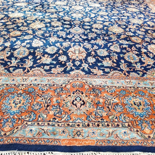 709 - A 19th century hand knotted Persian carpet, signed, in vivid tones of blue, terracotta and ivory, co... 