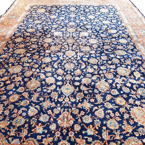 709 - A 19th century hand knotted Persian carpet, signed, in vivid tones of blue, terracotta and ivory, co... 