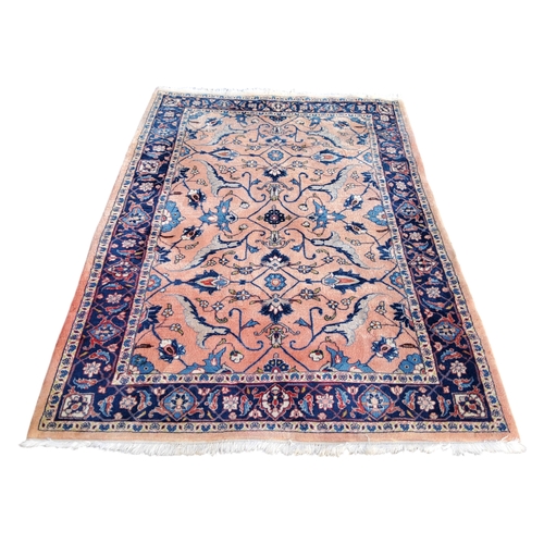 710 - An Oriental Sarouk carpet in tones of pink and blue, 266cm x 133cm