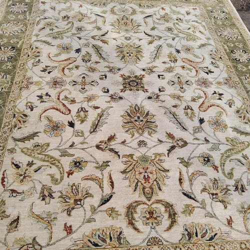 711 - An Oriental Gazani carpet, in subtle tones of olive green and ivory, hand knotted, 305cm x 230cm