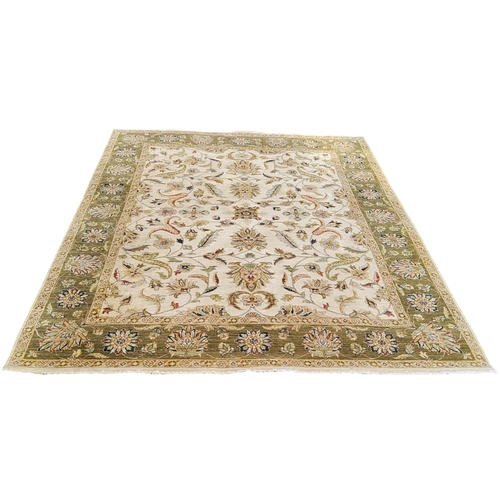 711 - An Oriental Gazani carpet, in subtle tones of olive green and ivory, hand knotted, 305cm x 230cm