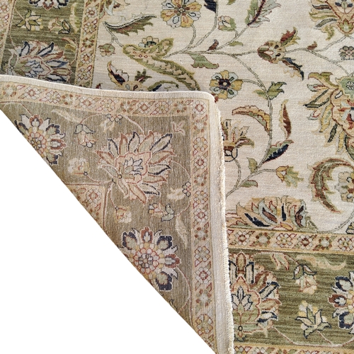 711 - An Oriental Gazani carpet, in subtle tones of olive green and ivory, hand knotted, 305cm x 230cm