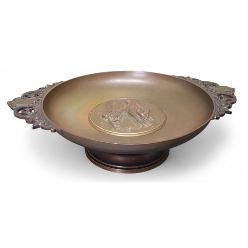 658 - A French bronzed two handled pedestal dish, the centre in relief with classical figure at a burning ... 