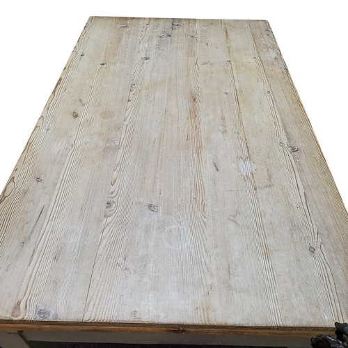 716 - A 19th century farmhouse pine drawer leaf dining table, over 9ft in length, planked stripped pine su... 