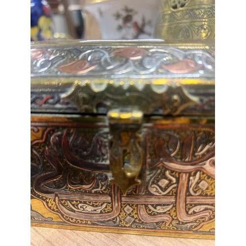 352 - A Middle Eastern canted rectangular silver and copper damascened brass casket, decorated in the Cair... 