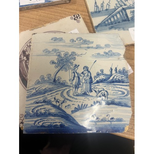 94 - 18th/19th century Dutch Delft tiles, blue and white with landscapes and figures; two others in manga... 