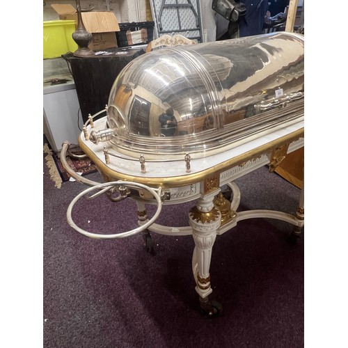 633 - A large and impressive E.P.N.S. meat carving trolley, domed retracting cover engraved with oval cart... 