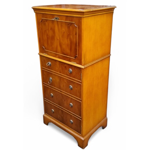 439 - A reproduction yew cocktail cabinet, fall front with mirrored interior, above four blind drawers, br... 