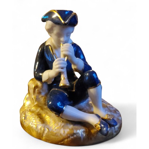 334 - A  Royal Worcester figure, of a Musician, as a seated boy, in 18th century costume, he playing ... 